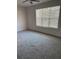 Bright bedroom with a large window and plush gray carpet flooring at 3004 Harvey Ave, North Charleston, SC 29405