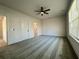 A spacious bedroom featuring neutral carpet, a ceiling fan, and natural light from a window at 3004 Harvey Ave, North Charleston, SC 29405