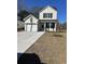 Charming two-story home with a garage, a well-manicured lawn, and classic black shutters at 3004 Harvey Ave, North Charleston, SC 29405