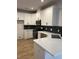 Modern kitchen features white cabinets, stainless steel appliances and black backsplash at 3004 Harvey Ave, North Charleston, SC 29405