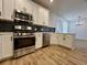 A modern kitchen featuring stainless steel appliances, white cabinetry, and a stylish backsplash at 3004 Harvey Ave, North Charleston, SC 29405