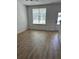 Living room with hard wood floors, white walls, window, and white trim at 3004 Harvey Ave, North Charleston, SC 29405