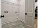 The mud room features gray wood-look tile, white walls, and shelving at 3004 Harvey Ave, North Charleston, SC 29405