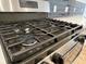 Close-up of a stainless steel gas stovetop with sturdy grates and modern controls at 3004 Harvey Ave, North Charleston, SC 29405