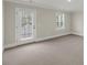 Bedroom with neutral carpet, white trim, and natural light from door and window at 304 O'Malley Dr, Summerville, SC 29483