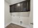 Laundry room with dark cabinets and wood look flooring at 304 O'Malley Dr, Summerville, SC 29483