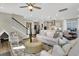 Open-concept living room featuring modern furniture, a ceiling fan, and hardwood floors at 304 O'Malley Dr, Summerville, SC 29483