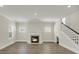 Open living room floor plan, featuring a fireplace, windows, and wood floors at 304 O'Malley Dr, Summerville, SC 29483