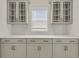 Detailed view of the pantry featuring neutral cabinets and a herringbone backsplash at 304 O'Malley Dr, Summerville, SC 29483