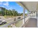 Covered front porch with white railings and views of the street and community at 304 O'Malley Dr, Summerville, SC 29483