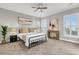 Cozy bedroom features neutral paint, modern art, shutters, and a ceiling fan at 313 Bloomington Way, Summerville, SC 29486