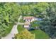 An aerial view features a charming home with ample parking, set back from the road amidst lush greenery at 317 Lankford St, Moncks Corner, SC 29461