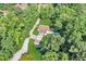 An aerial shot shows the property with a long driveway and green space surrounded by mature trees at 317 Lankford St, Moncks Corner, SC 29461
