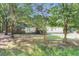 View of single-story home nestled in a verdant setting, enhanced by mature trees at 317 Lankford St, Moncks Corner, SC 29461