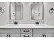 Bright bathroom featuring double sinks with modern fixtures, framed mirrors, and elegant overhead lighting at 324 Abercom Place Dr, Moncks Corner, SC 29461