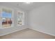 Bedroom featuring neutral carpeting, two large windows, and light gray walls at 324 Abercom Place Dr, Moncks Corner, SC 29461