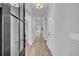 Bright hallway with wood floors leads to the living area with lots of natural light at 324 Abercom Place Dr, Moncks Corner, SC 29461