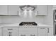 A modern kitchen features white cabinets, a white backsplash, stainless steel appliances, and a gas cooktop at 324 Abercom Place Dr, Moncks Corner, SC 29461