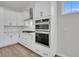 A modern white kitchen features stainless steel appliances, bright lighting, and a functional gas cooktop at 324 Abercom Place Dr, Moncks Corner, SC 29461