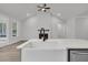 Open-concept living room with fireplace and large windows, seamlessly connected to the kitchen area at 324 Abercom Place Dr, Moncks Corner, SC 29461