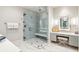 Stylish bathroom featuring glass enclosed shower and vanity with seated makeup area at 32-E Prioleau St, Charleston, SC 29401