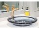 Close-up of a sophisticated blue glass sink and stylish gold faucet enhancing the bathroom's elegance at 32-E Prioleau St, Charleston, SC 29401