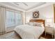 Bright bedroom with a wooden bed frame, patterned rug, and a decorative ceiling fan at 32-E Prioleau St, Charleston, SC 29401