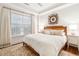 Bright bedroom with a wooden bed frame, patterned rug, and decorative wall art at 32-E Prioleau St, Charleston, SC 29401