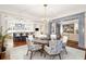 Open concept dining room with a modern chandelier, seating for six, and a view to the kitchen at 32-E Prioleau St, Charleston, SC 29401