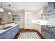 Bright kitchen with custom blue and white cabinetry, marble counters, and high-end appliances at 32-E Prioleau St, Charleston, SC 29401