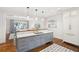 Open concept kitchen featuring custom cabinets, an island and stainless steel appliances at 32-E Prioleau St, Charleston, SC 29401