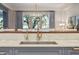 Close-up of a kitchen featuring marble countertops and brass fixtures at 32-E Prioleau St, Charleston, SC 29401