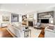 Spacious living room showcasing custom built-in shelving, stone fireplace, and hardwood flooring at 32-E Prioleau St, Charleston, SC 29401
