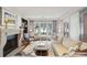 Bright living room featuring a fireplace, hardwood floors and large windows with lots of natural light at 32-E Prioleau St, Charleston, SC 29401
