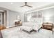 Spacious bedroom with a stylish four poster bed, ceiling fan, and desk at 32-E Prioleau St, Charleston, SC 29401