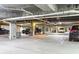 Well-lit and organized parking garage with marked spaces and overhead pipes at 32-E Prioleau St, Charleston, SC 29401