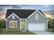 Charming, two-story home with gray siding, white trim, a white garage door and a well-manicured lawn at 332 Dickerson Ln, Lincolnville, SC 29485