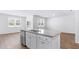 Kitchen island with sink, stainless steel appliances, and views into the living area with outdoor access at 332 Dickerson Ln, Lincolnville, SC 29485