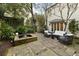 Beautiful backyard with a stone patio, water feature, and manicured landscaping at 35 Tradd St, Charleston, SC 29401