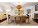 Open dining room with hardwood floors, a fireplace, and decorative lighting at 35 Tradd St, Charleston, SC 29401