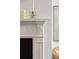 Close-up of a white fireplace mantel showcasing detailed molding and decorative accents at 35 Tradd St, Charleston, SC 29401