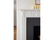 Close-up of a detailed white fireplace mantel with a black firebox and decorative candles at 35 Tradd St, Charleston, SC 29401
