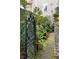 Ornate gate to a lush garden path, creating a tranquil and inviting entrance at 35 Tradd St, Charleston, SC 29401