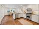 Bright kitchen featuring stainless steel appliances, white cabinets, and hardwood floors at 35 Tradd St, Charleston, SC 29401