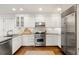 Bright kitchen featuring stainless steel appliances, white cabinets, and hardwood floors at 35 Tradd St, Charleston, SC 29401