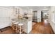 Bright kitchen with breakfast bar, stainless appliances, white cabinets, and hardwood floors at 35 Tradd St, Charleston, SC 29401