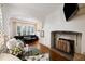 Bright living room with hardwood floors, a fireplace, and large windows at 35 Tradd St, Charleston, SC 29401