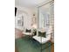 Bright living room featuring hardwood floors, stylish chairs, and curtains at 35 Tradd St, Charleston, SC 29401
