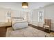 Bright main bedroom with large rug, neutral colors, and multiple windows for ample natural light at 35 Tradd St, Charleston, SC 29401