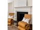 Sitting room with stylish chairs, glass table, fireplace, and decorative accents at 35 Tradd St, Charleston, SC 29401